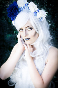 woman wearing white and blue floral headdress thumbnail