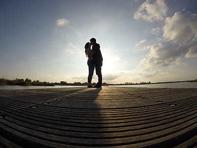 silhouette of kissing man and woman fish-eye photography thumbnail
