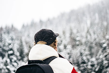 selective focus photography of person near forest with snow thumbnail
