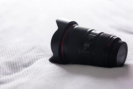 black DSLR lens on white surface thumbnail