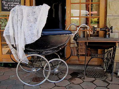 photo of pram stroller beside threadle sewing machine thumbnail