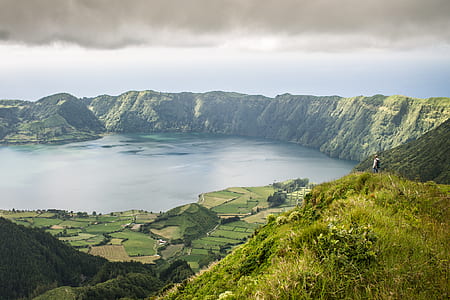 photography of lake surrounded by mountains thumbnail