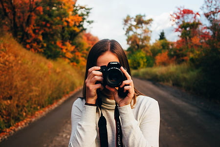 photo of woman holding camera thumbnail