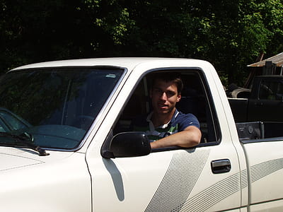 man in white regular cab thumbnail