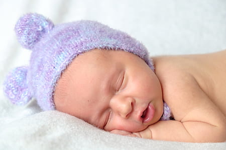 sleeping baby in purple beanie thumbnail