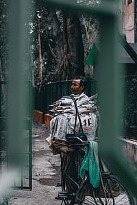 man standing behind the bicycle thumbnail