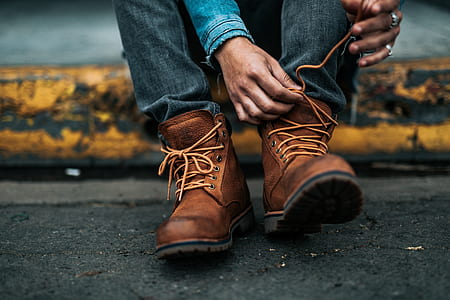 person wearing brown leather boots thumbnail