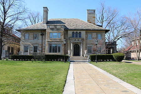 grass field in front of gray house thumbnail