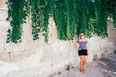 girl standing beside the wall thumbnail
