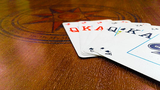assorted playing cards on brown surface thumbnail
