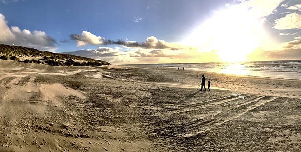 Photo of People Walking on Brown Sand thumbnail