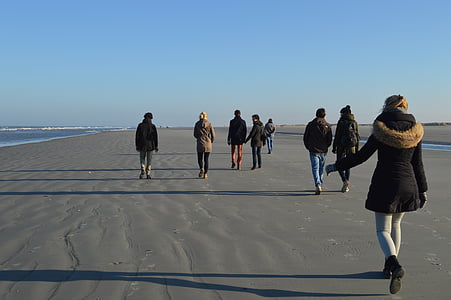 group of people walking on sand thumbnail