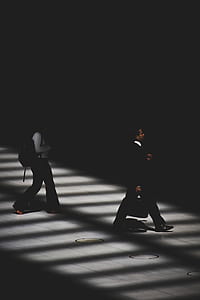 man walking with black suit during daytime thumbnail