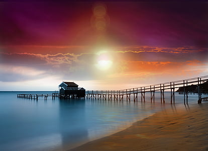 silhouette photography of bridge house near body of water thumbnail