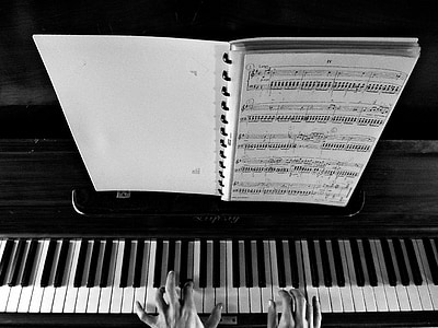 grayscale photography of person playing piano thumbnail