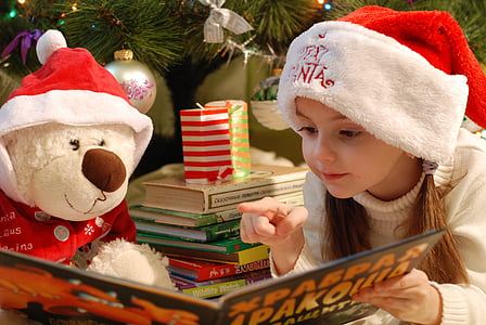 girl sitting besixe white teddy bear reading book thumbnail