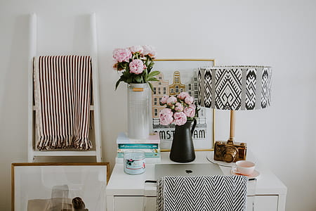 pink petaled flower on black vase thumbnail