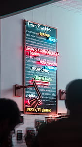 Neon sign on white painted wall thumbnail