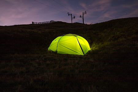 green dome tent under gray and black sky thumbnail