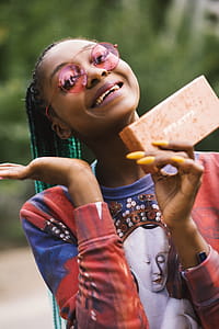 Woman Smiling While Holding Box thumbnail