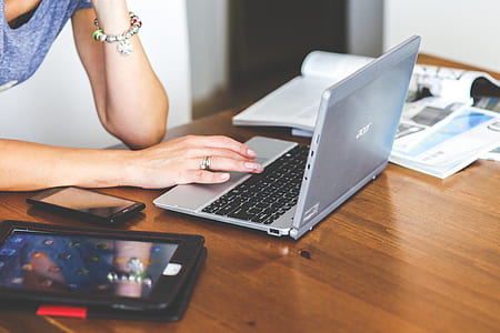 Close-up of woman typing on keyboard of laptop thumbnail