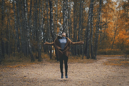 woman on star near trees thumbnail