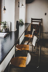 four brown wooden bar chairs beside desk thumbnail
