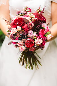 woman holding red and pink flower bouquet thumbnail