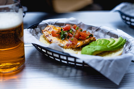 fried dish inside serving tray beside clear drinking glass with beer thumbnail