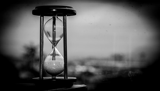 gray scale photo of sand clock thumbnail