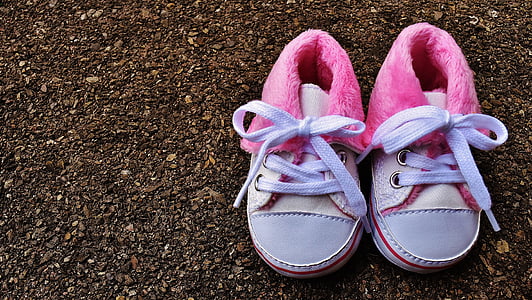 children's pair of pink-and-white shoes on ground thumbnail