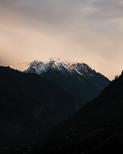 mountain under cloudy sky during daytime thumbnail