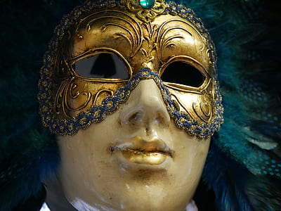 person in gold mask figurine thumbnail