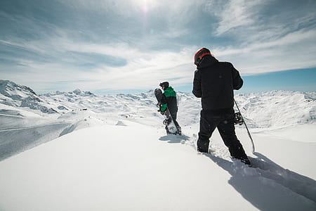 two men walking on ice capped field during blue sky thumbnail
