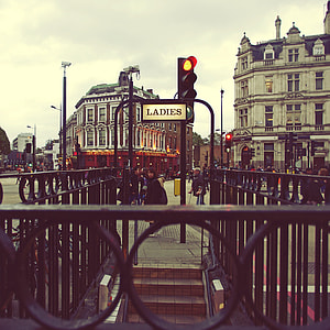 woman standing beside ladies signage outdoors thumbnail