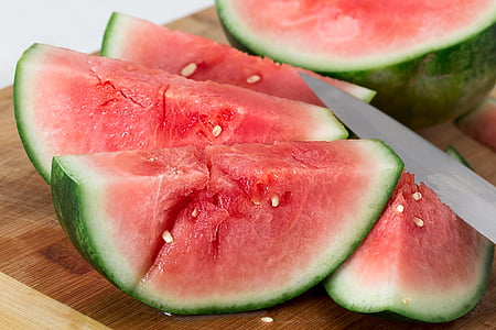 sliced water melon on brown wooden chopping board thumbnail