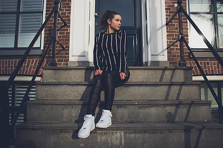 woman sitting on stairs beside closed door thumbnail