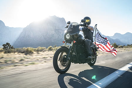 man riding black cruiser motorcycle thumbnail