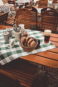 donut in brown wicker near a glass of beer thumbnail