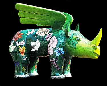 green and multicolored rhinoceros with wings figurine thumbnail