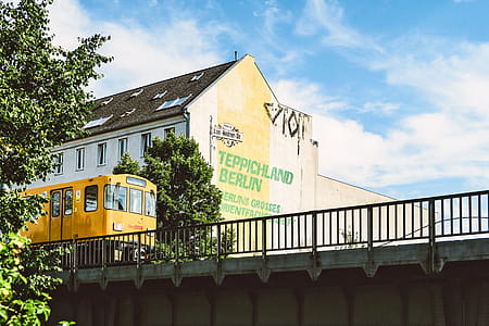 Yellow Train Beside Teppichland Berun Building thumbnail