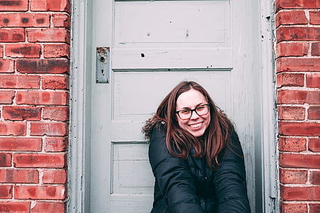woman sitting beside closed door thumbnail