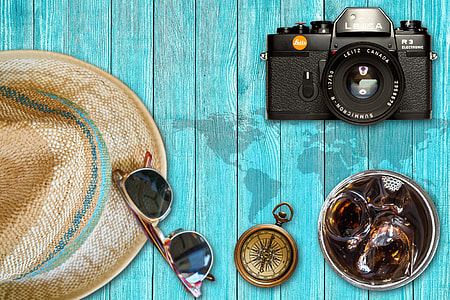 brown sunglasses beside brass compass thumbnail