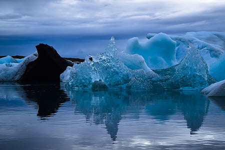 gray iceberg beside calm body of water thumbnail