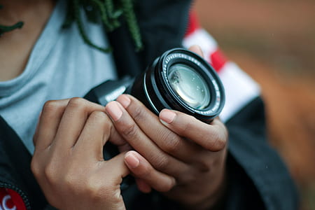 person holding black DSLR camera thumbnail