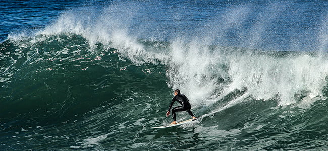 person surfboarding during daytime thumbnail