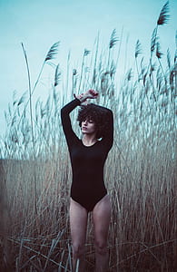 woman standing surrounded brown tall grass taken at daytime thumbnail
