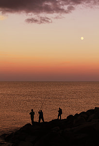 silhouette of people fishing during golden hour thumbnail