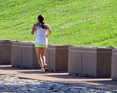 woman running near brown concrete obstacles thumbnail