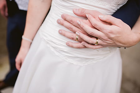 top view photo of coupe holding hands with rings thumbnail